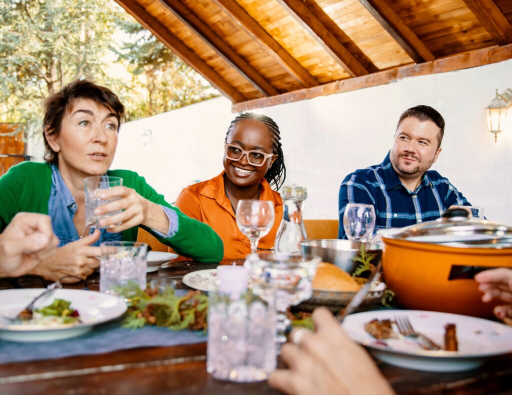 a group of people having a good time eating a meal together