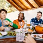 a group of people having a good time eating a meal together